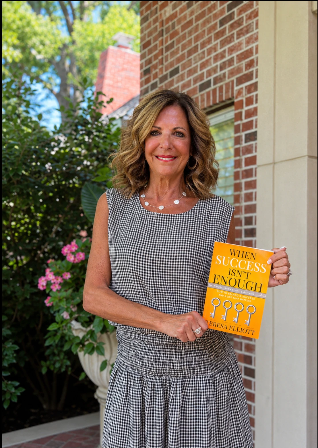 Teresa Elliott holding her book When Success Isn't Enough